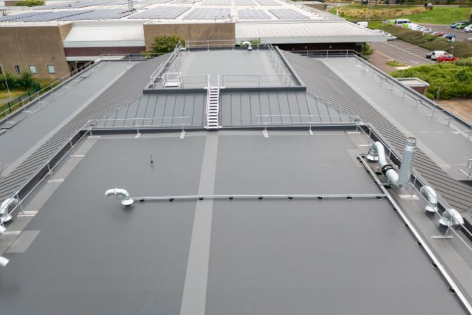 Single ply overlay to an existing metal roof